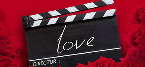Clapperboard and roses with love written on it, romantic film concept